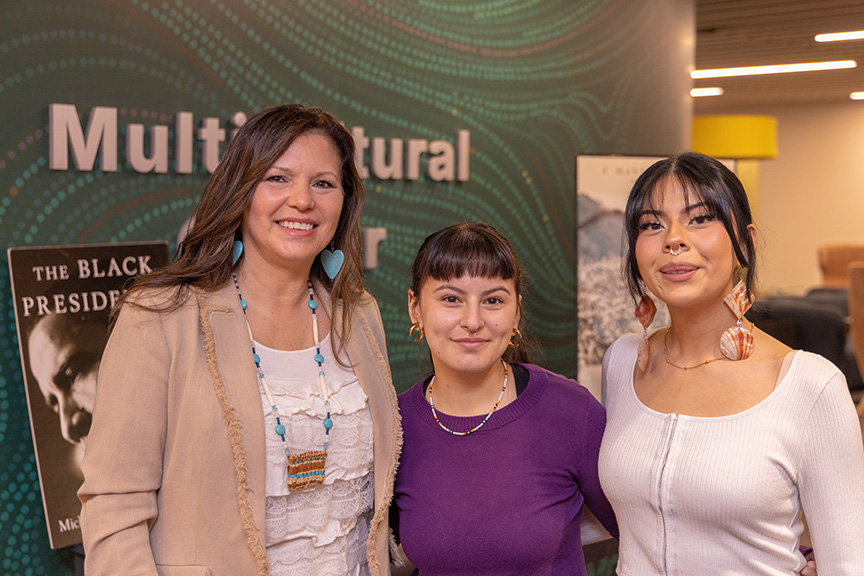 Zoe Higheagle Strong poses for a photo with two students at the February 19 open house.
