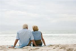 Elderly Couple Sitting on Beach