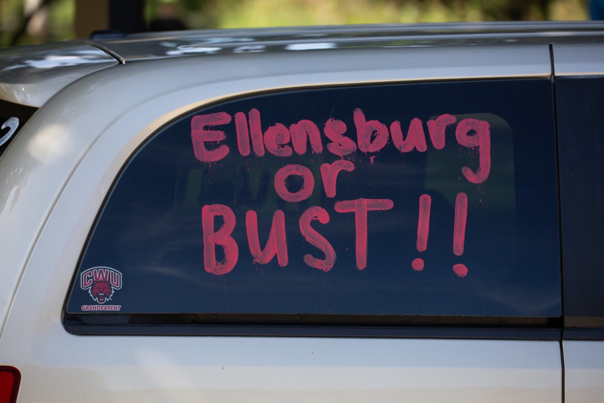 Van window saying "Ellensurg or Bust"