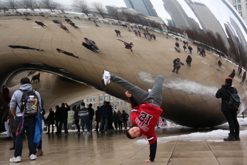 USHLI participant, Edwin Rodriguez, break dancing in front of Cloud Gate in Chicago