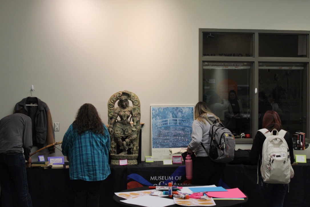 People looking at the thrifted items displayed at curating connections