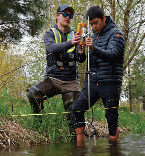 Student and professor installing pipe