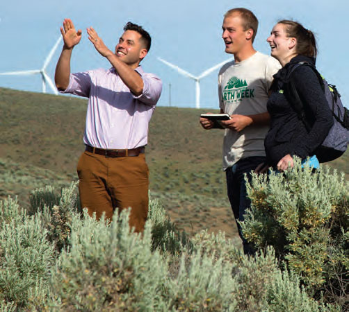 Students in front of wind turbines