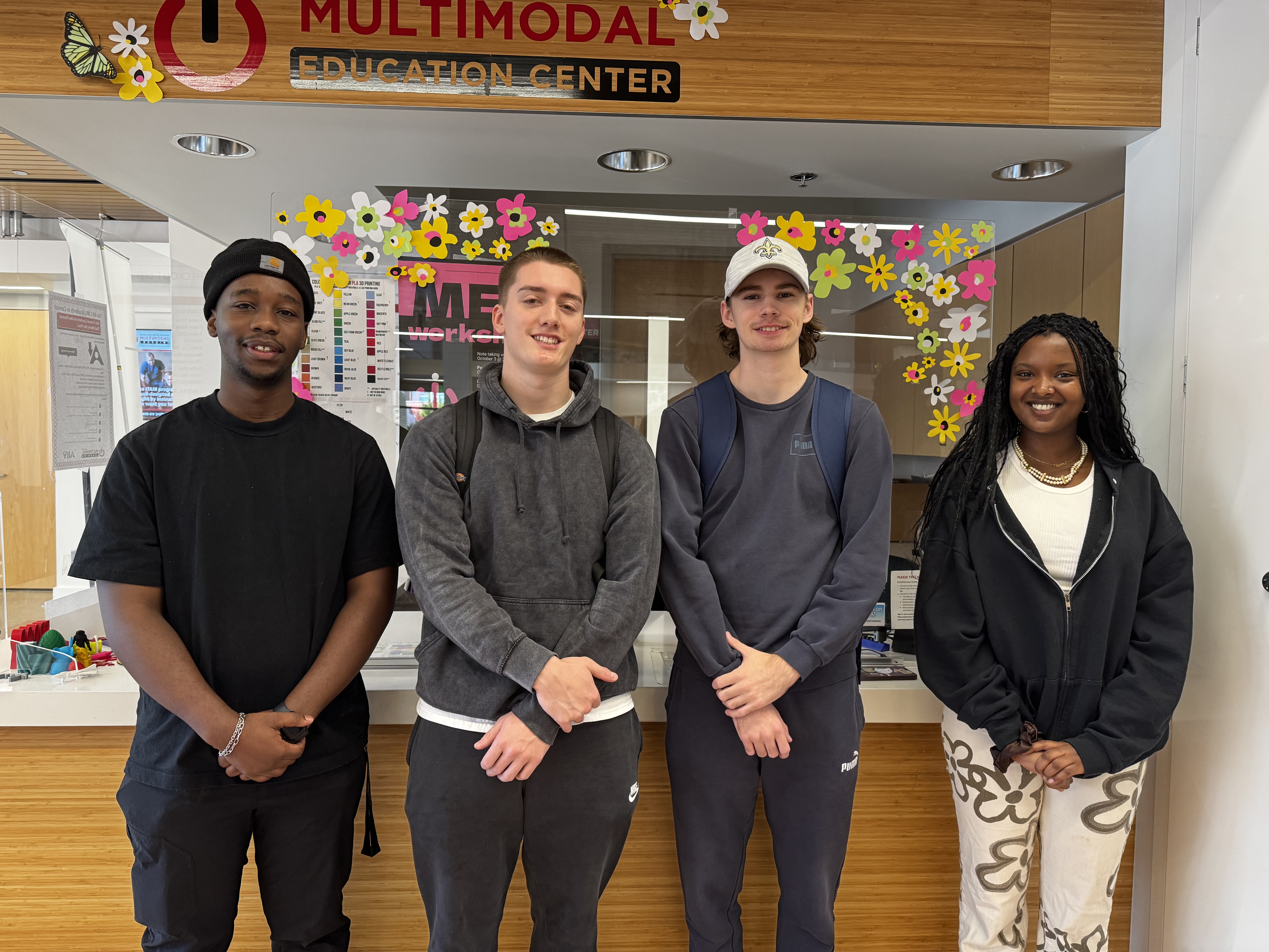Student staff of the MEC in front of our Checkout kiosk in Samuelson 