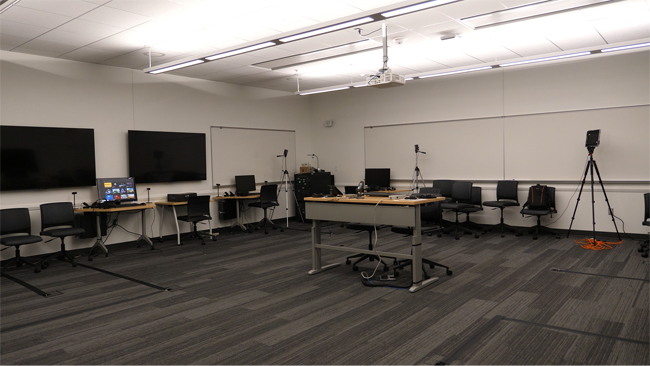 VR lab in Samuelson 124 with monitors and headsets set around room.