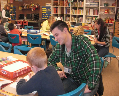 Teacher assisting student