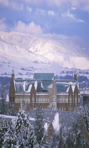 CWU Science building with snow on the roof with snow covered hills in the background
