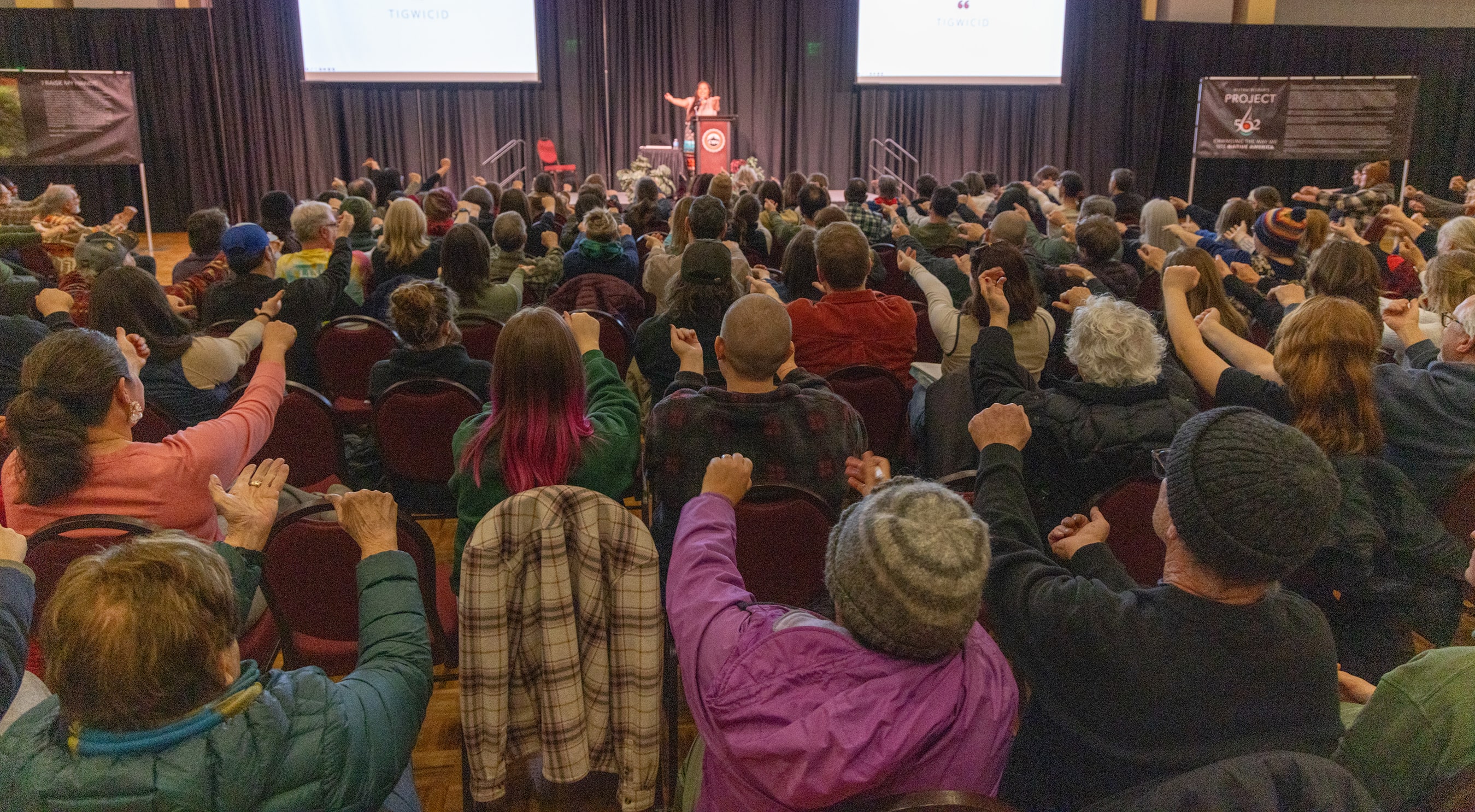 Crowd participating at an artist talk.