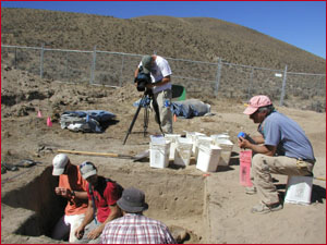 Student Andy Hanson films excavation in Unit 1 while Dr. Morris Uebelacker observes.