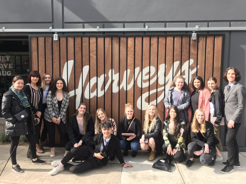 Students posing in front of Harveys