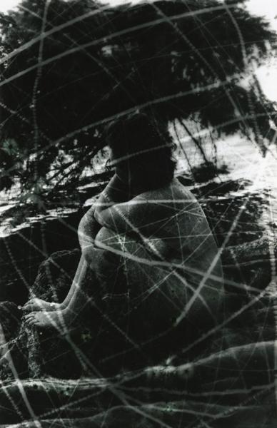 a nude woman with white shadows or scratches all over the image.