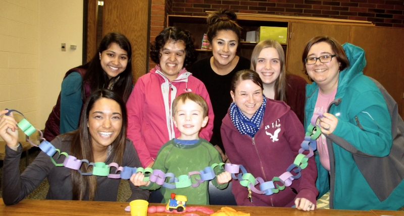 student volunteers playing with a child