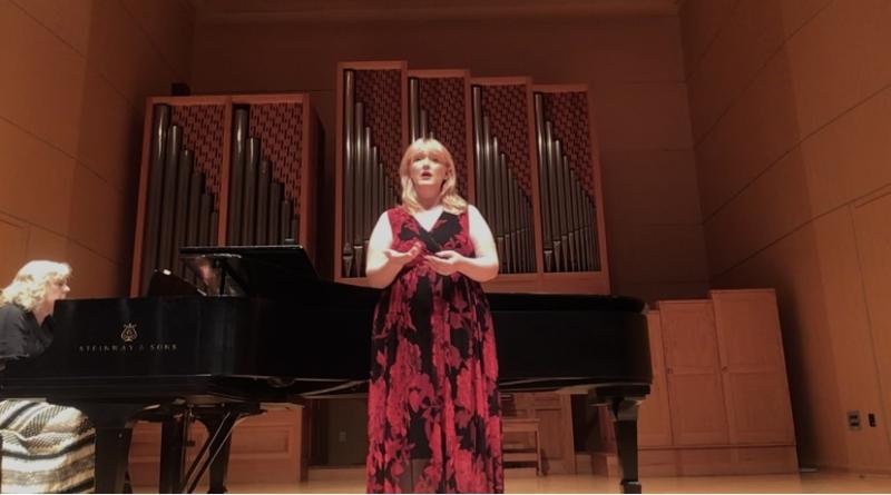 Singer in front of pipe organ