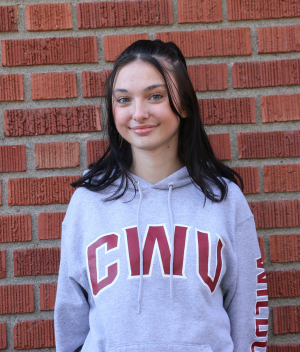 young woman with dark brown straight hair in grey CWU crewneck hoodie