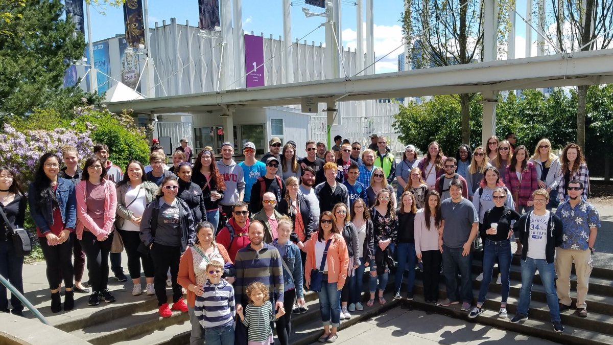 Large group of CWU students posing for a picture in front of the Seattle Science Museum. 