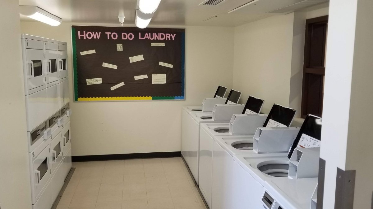 DHC laundry facility with a sign board that states, "How to do Laundry".