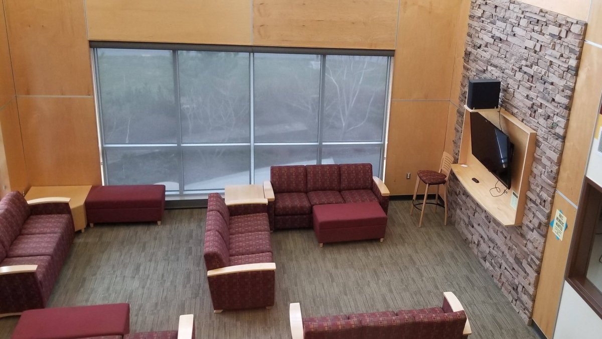 Douglas Honors lounge area with a TV and couches.
