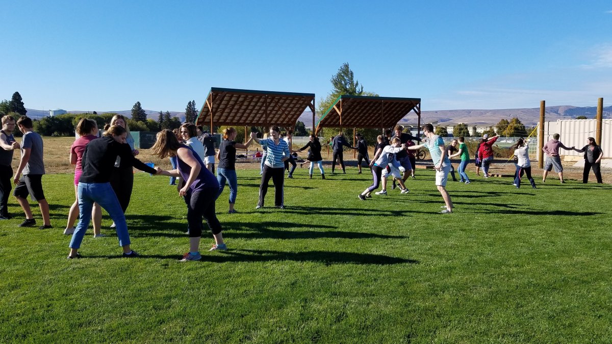 CWU DHC students playing in a field.