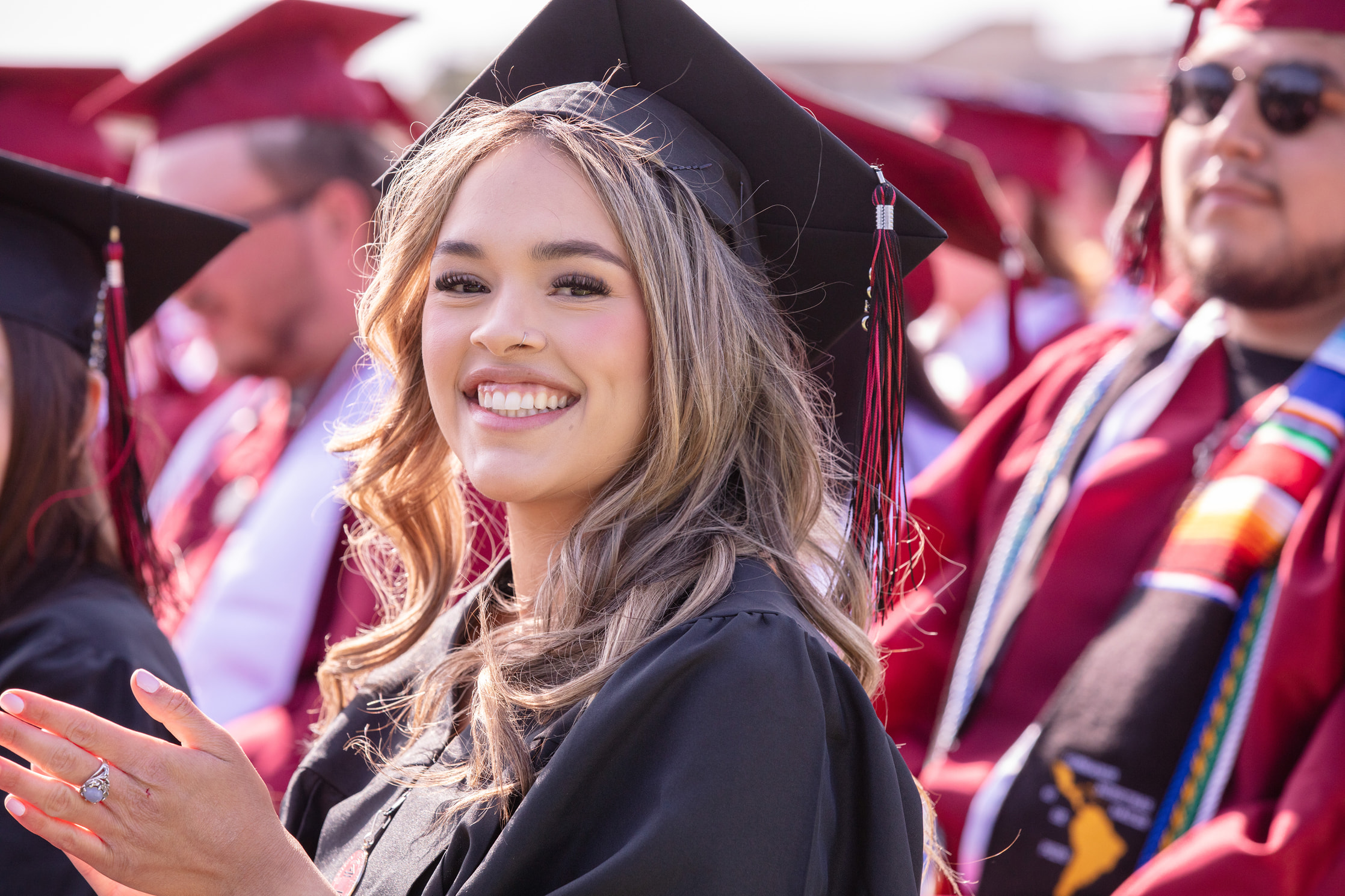 Student smiling during commencement ceremony.