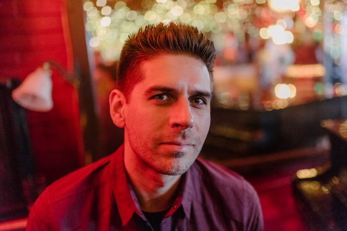 Author photo of Carlos Andres Gomez looking seriously into the camera
