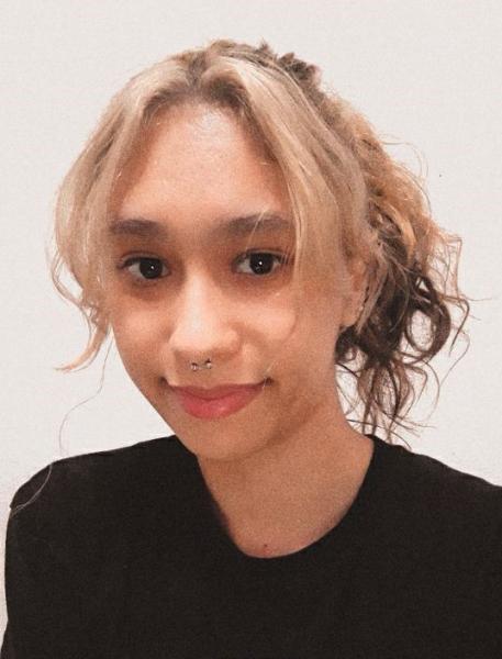 A close up photo of Karla Maravilla wearing a black top.