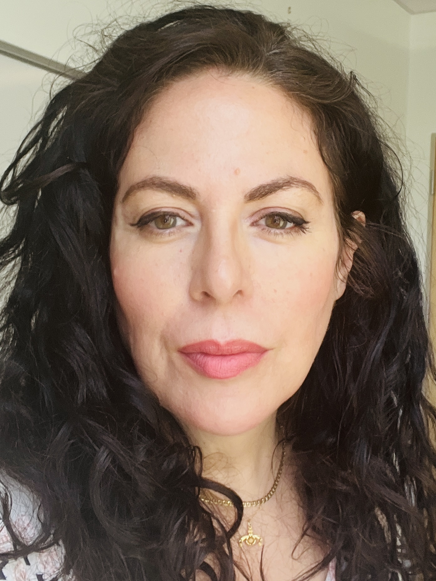 Candace Walsh staring directly into the camera with dark hair framing her face