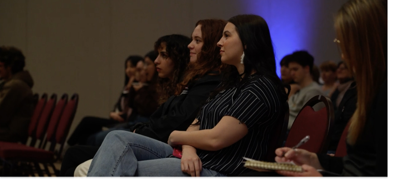Students seated, gaining insightful knowledge from a panel 