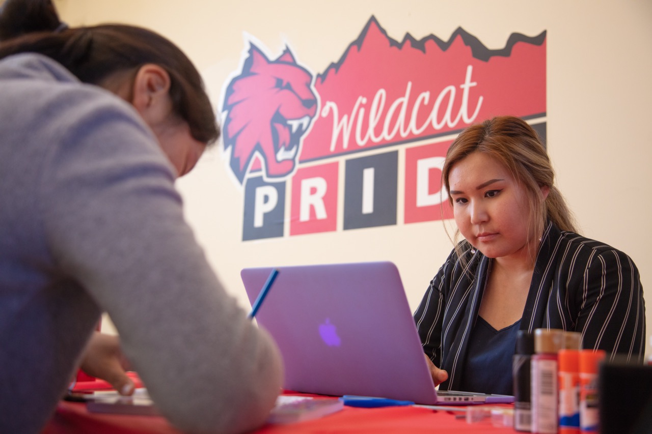 Two CWU students seated at a table studying.