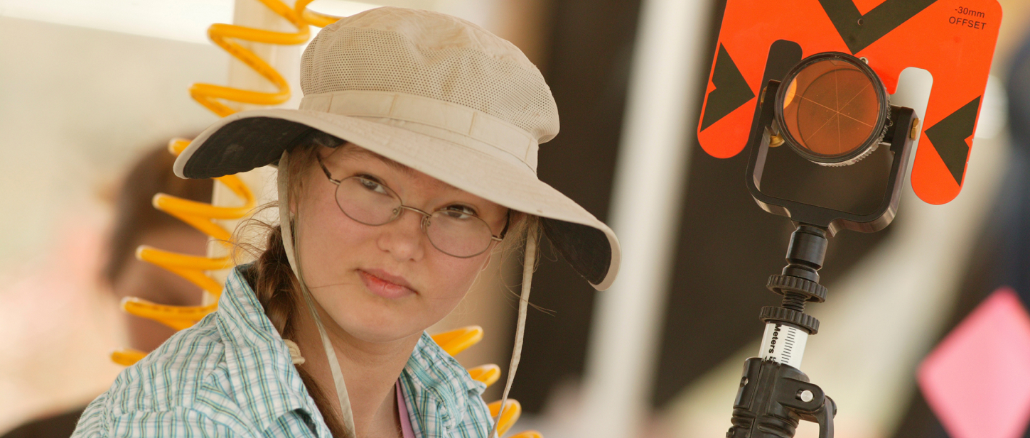 Student working with specialized equipment during a mammoth dig