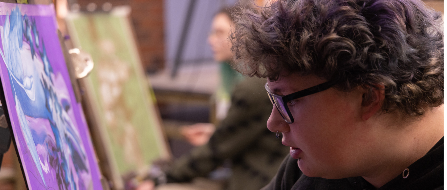 Student painting something very purple