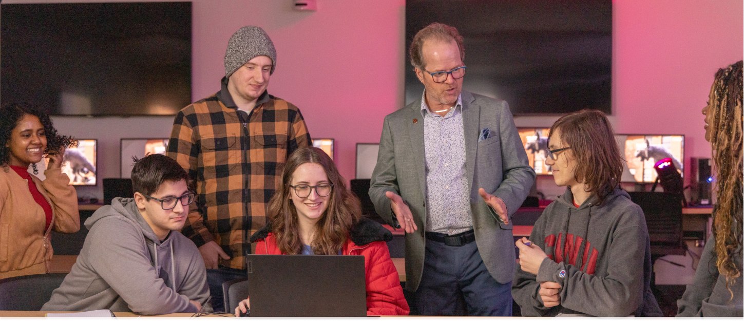 Professor teaching a group of Computer Science students