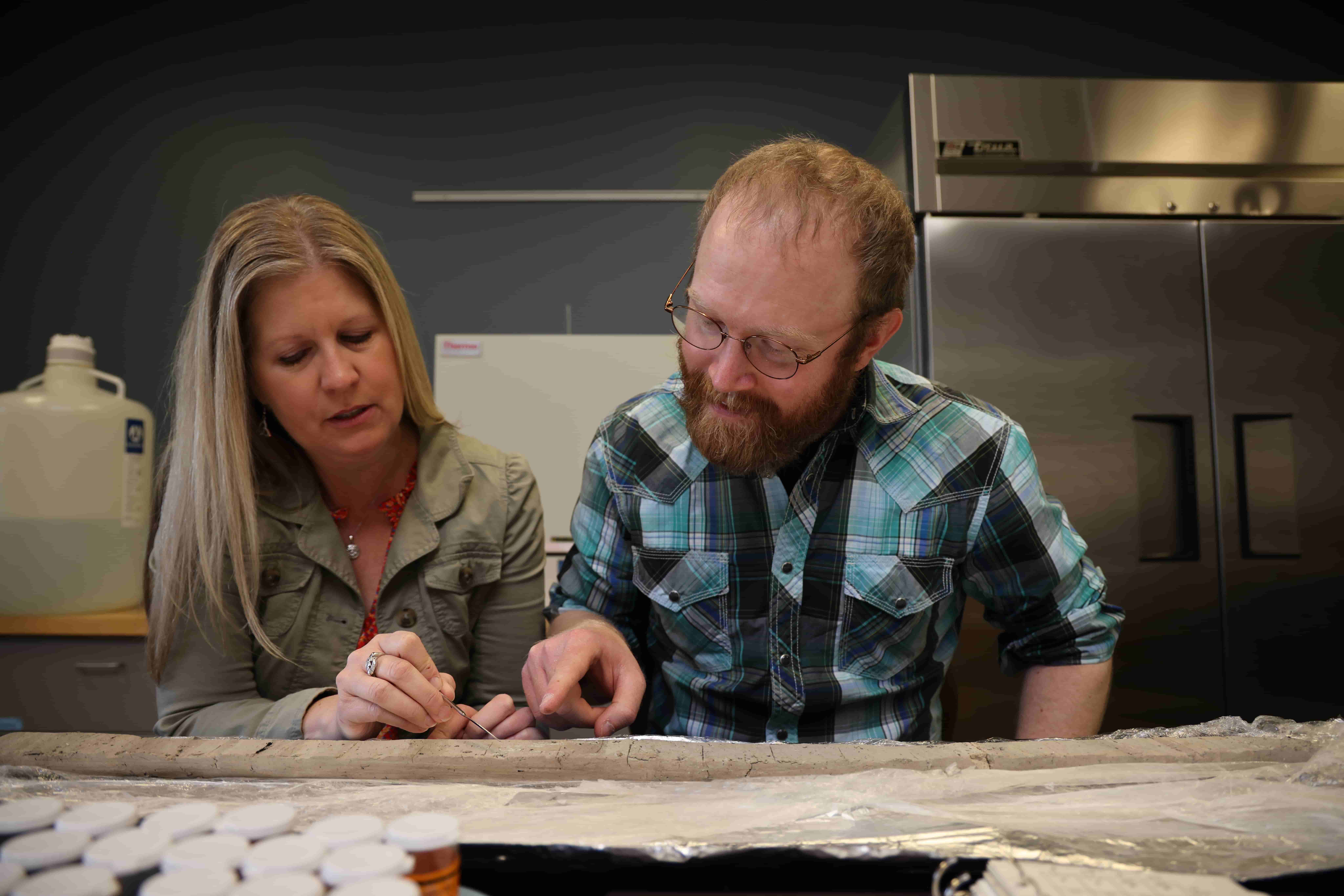Student working with professor on an ash research project.