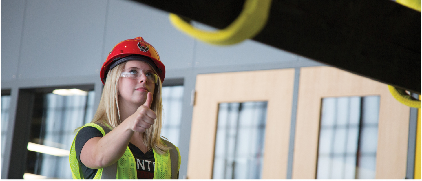 Student giving the thumbs up for a construction project.