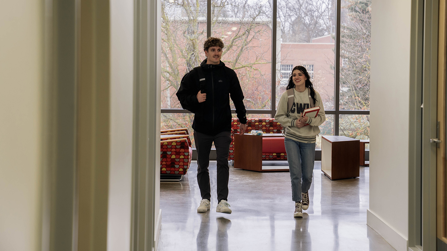 Two students walking down the hall together