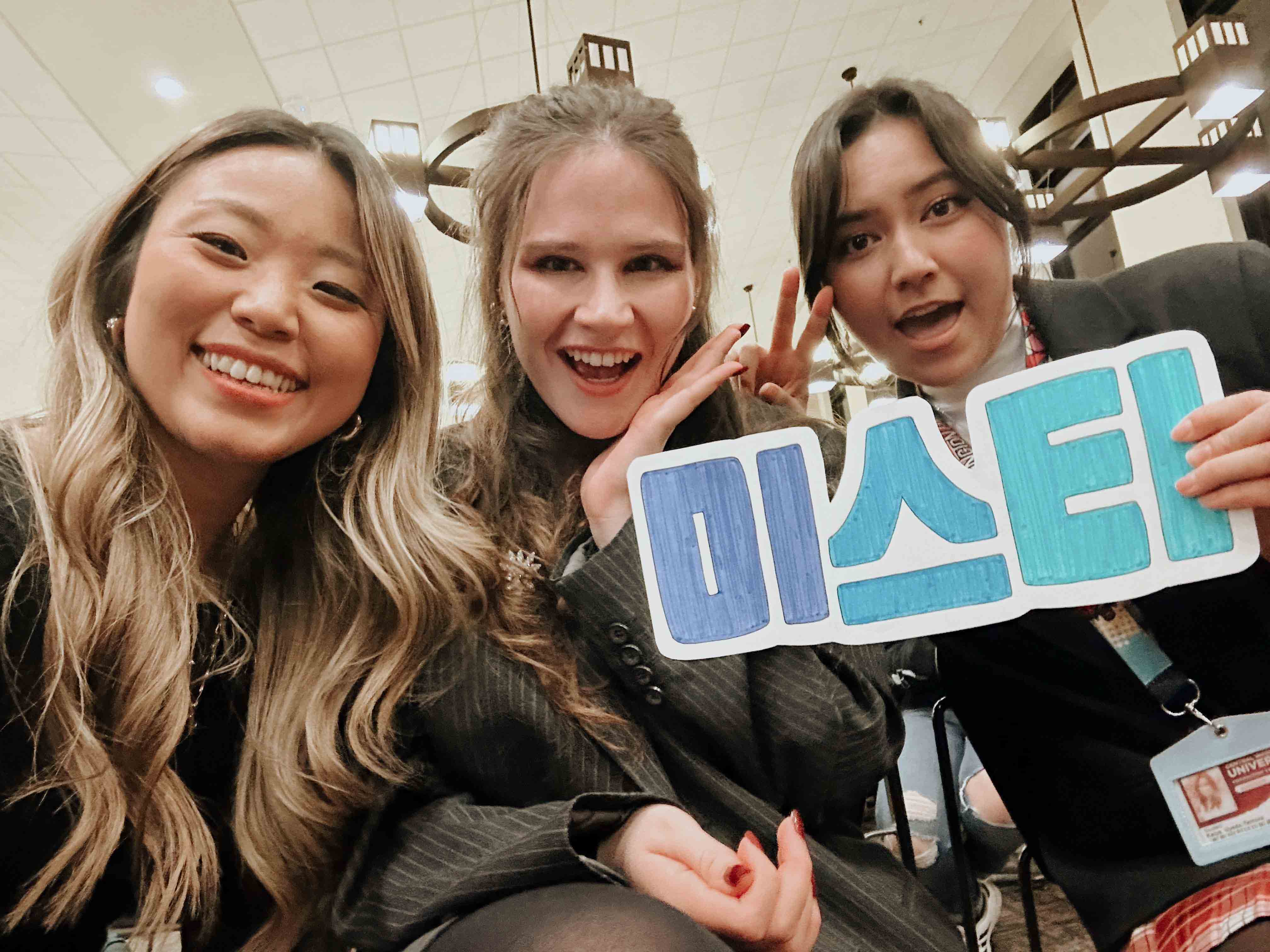 Korean studies professor poses with students in a selfie
