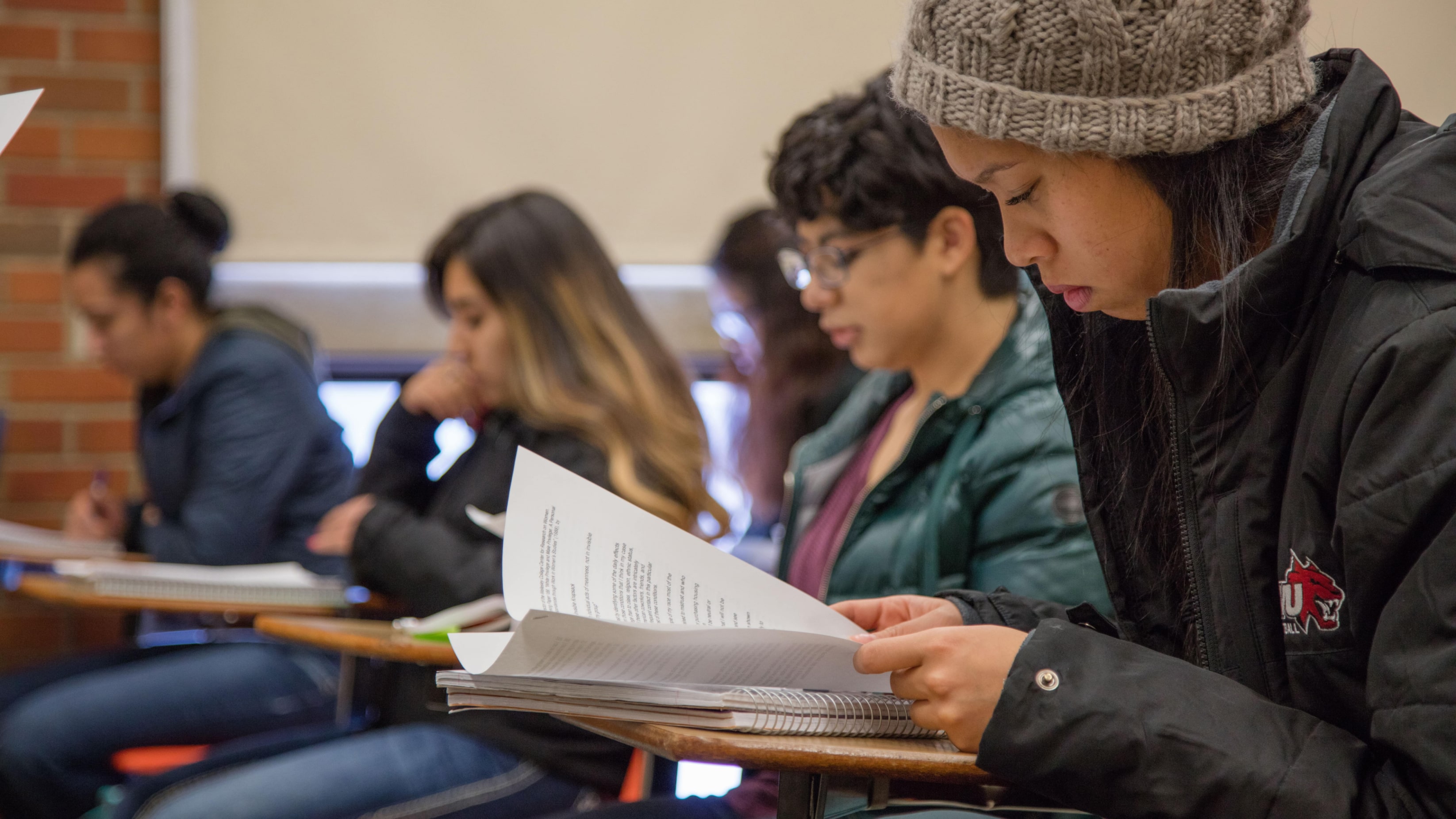 Student reading a book during class