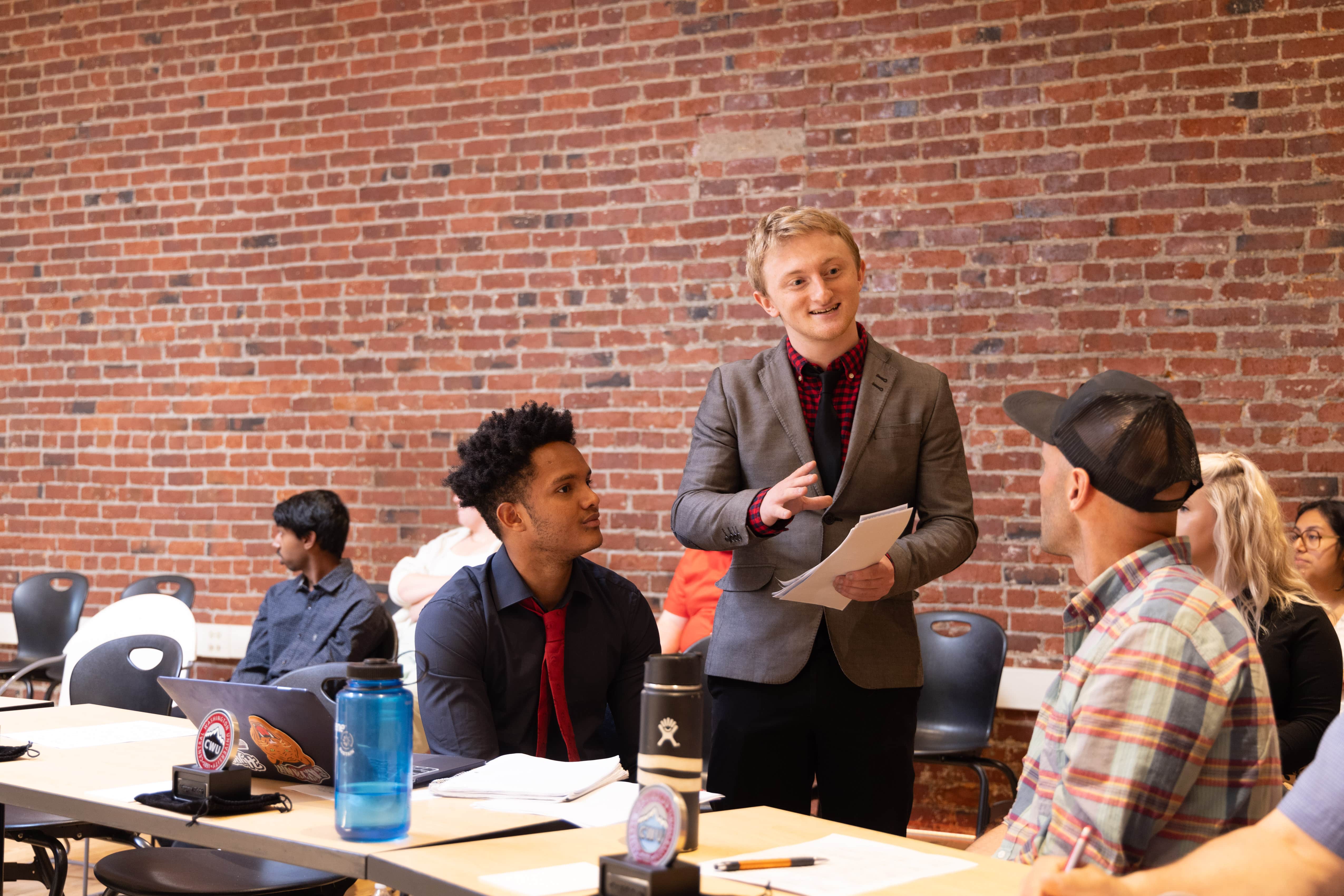 Students pitching a product to a panel during a business event