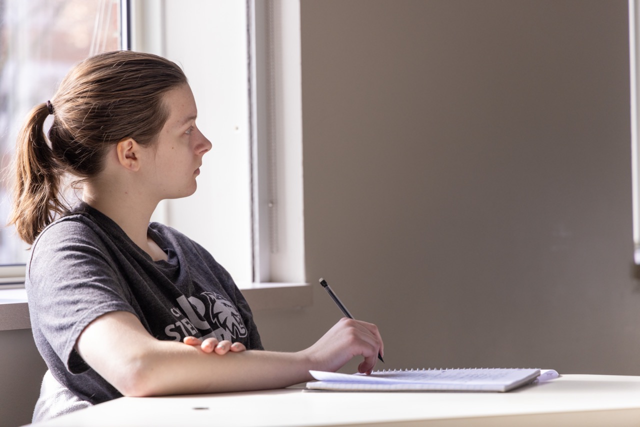 Student looking out the window very pensively.