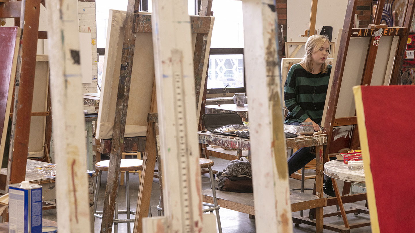 Art student working at an easel