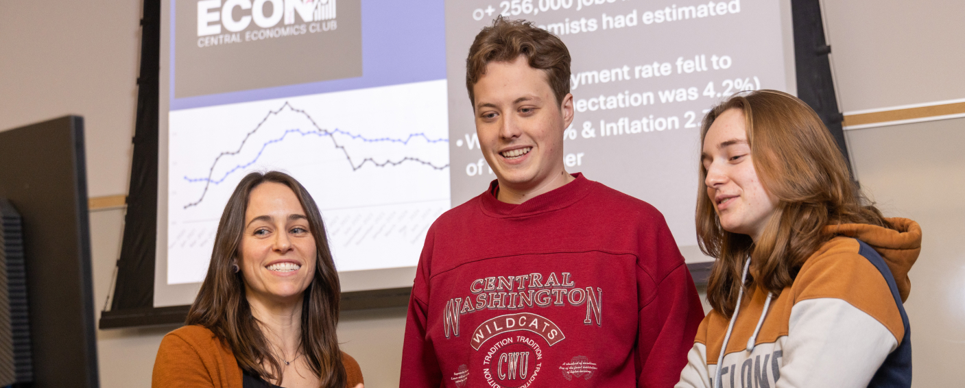 Students connecting with a professor outside of the classroom for individualized support.
