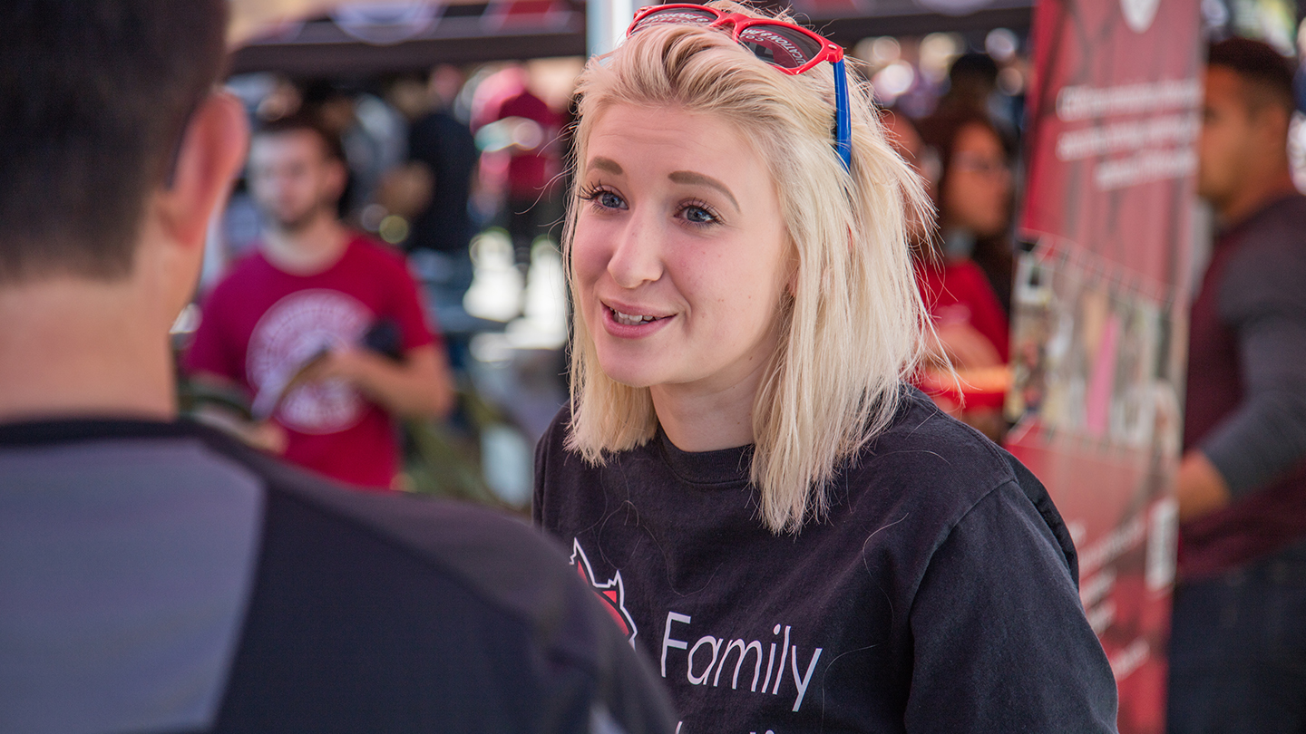 Student engaging with peers during a CWU Event
