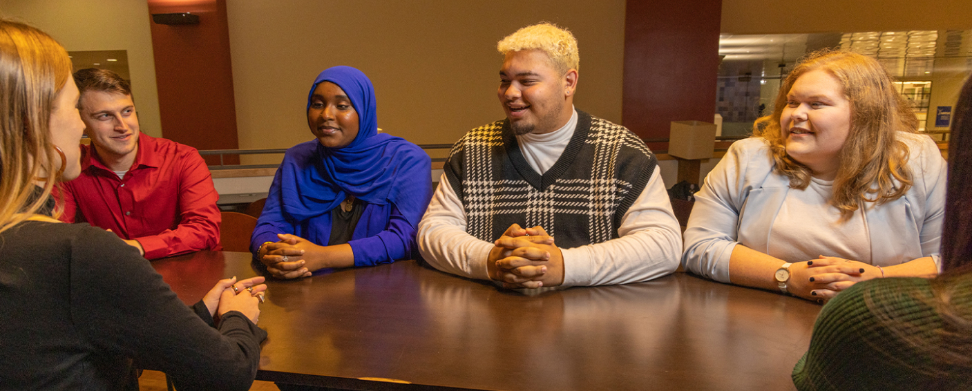 Students sitting around a table for a discussion.