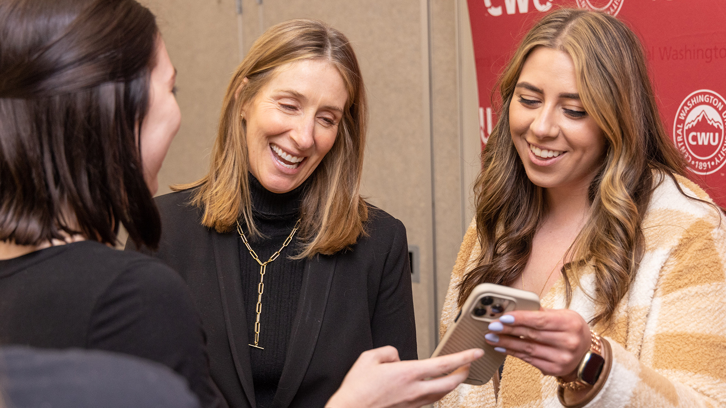 happy cwu people looking at a phone