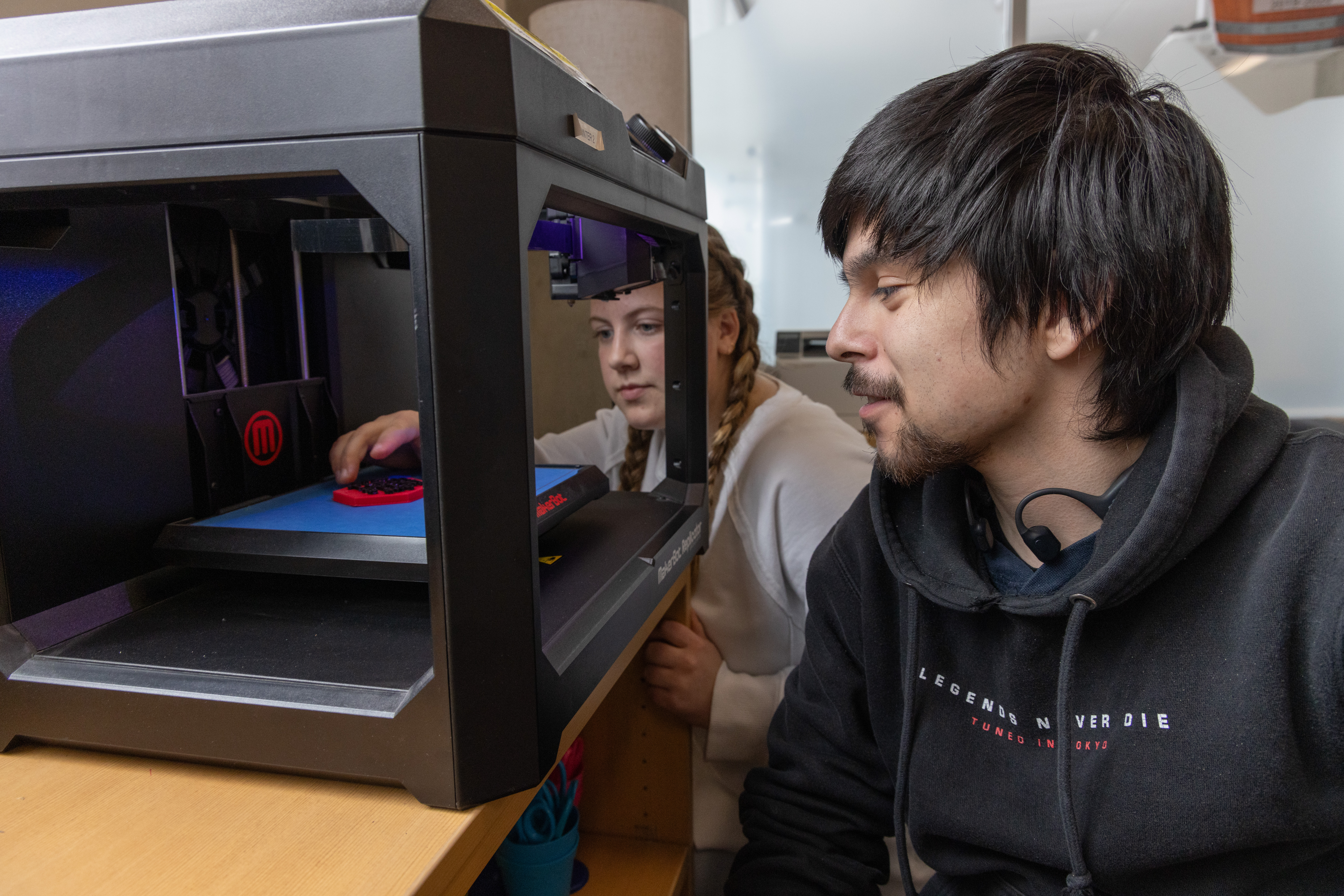 CWU STEM Teaching students pointing at DNA helix sculpture.