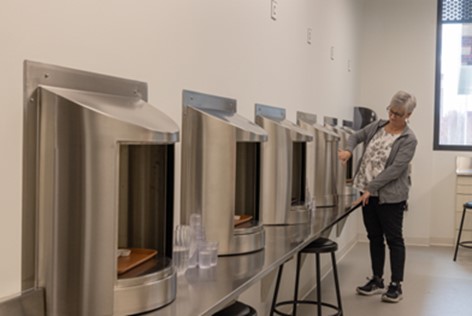 A woman putting food inside a booth