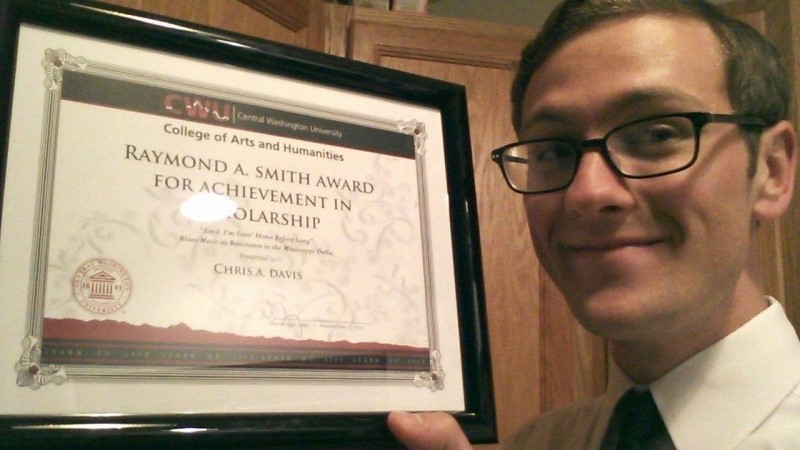 Person in front of their Scholaship award