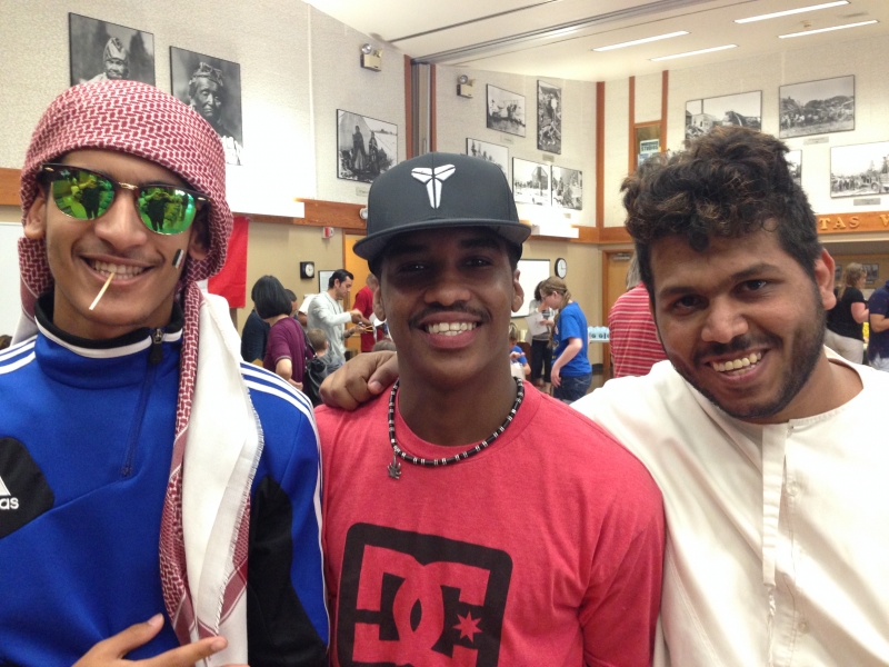Three students smiling at the camera