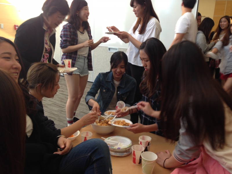 Students earring around a table.