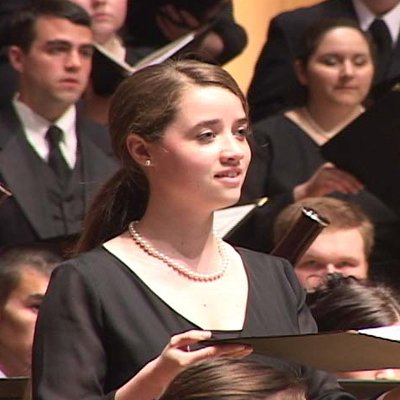 Close up photo of a former student performing as a featured soloist in Beethoven's 9th Symphony.