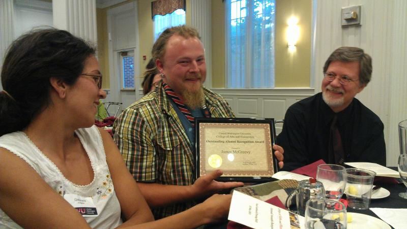 Jim McGreevy holding his award